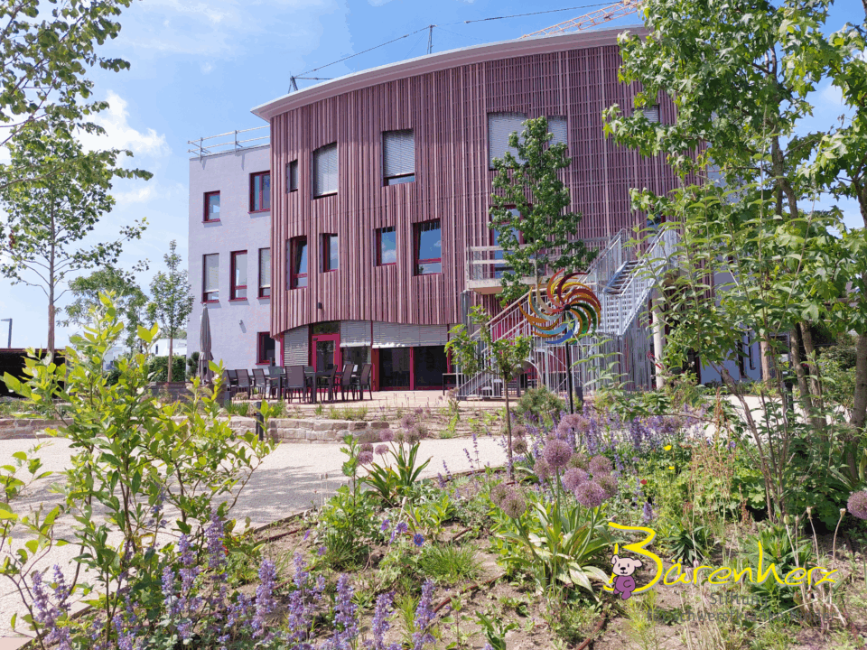 Inviting, natural extension to children's hospice with colorful garden